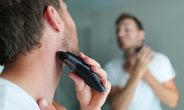 an awesome daddy image - man shaving beard using electric trimmer