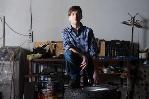 life skills every teen should know before graduation - teen working on car