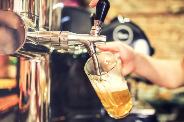 don't you remember - bartender hand at beer tap pouring a draught lager beer serving in a bar