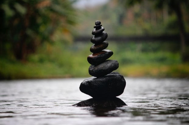 Ways To Calm Yourself Down - stones stacked on top of each other in a calm pool of water