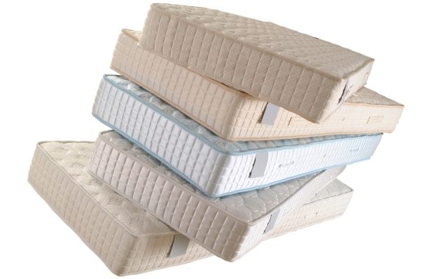 improving your physical health by sleeping better - various stacked mattresses