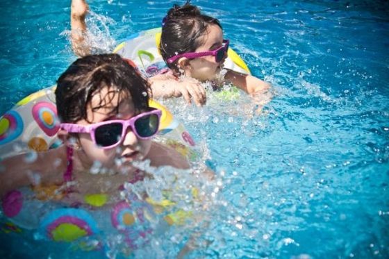 important skills kids should pick up through play - two kids swimming
