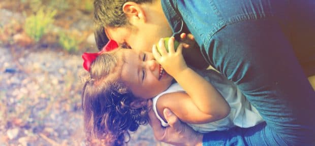 instilling a positive mental outlook in your child - Stepdad embracing his stepdaughter