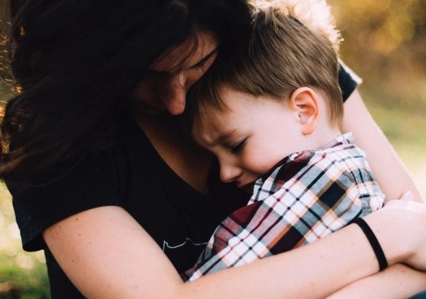 helping your child cope with loss and tragedy - mother comforting her child