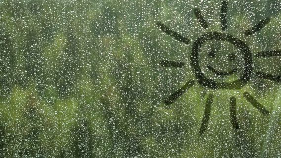 Rainy Day Activities For Stepfamilies -Window with rain and a finger sketch of the sun