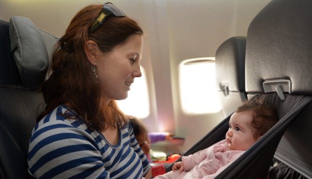 Mother carry her infant baby during flight
