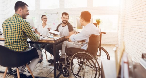 how to interact with a person in a wheelchair-a man in a wheelchair talking with other people