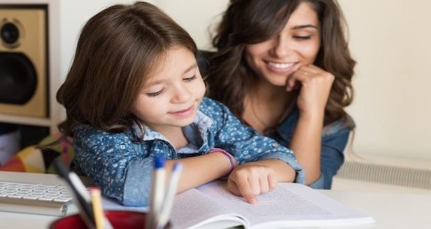 Helping your children love reading - mom joining her daughter in reading