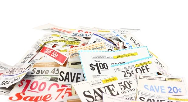 how to stretch family budget with coupons-a pile of coupons against a white background