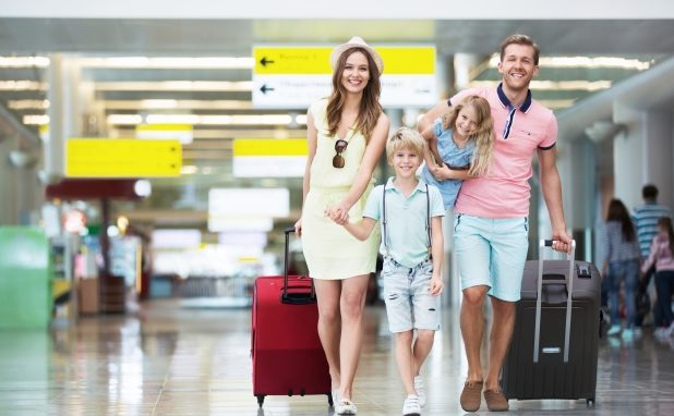 family of four moving through airport