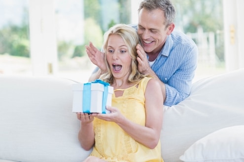 husband surprising wife with gift