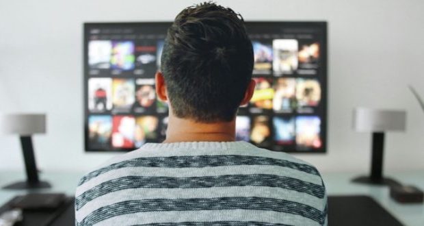 what binge watching does to your eyesight-a man watching the TV