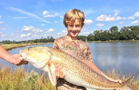 life lessons fishing can teach kids-a boy holding a big fish