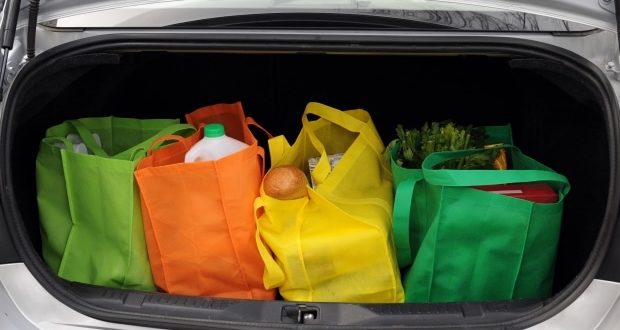 various colored grocery bags in car