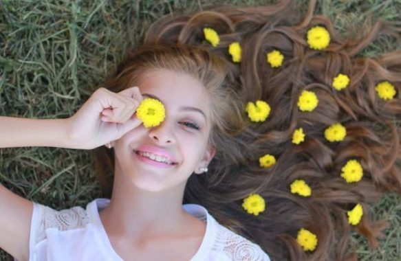 helping your teen develop self-esteem-teen girl with flowers