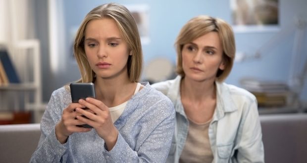 how to help your child with addiction -smartphone addicted teen with frustrated mom