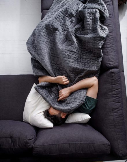 Tech father's day gift ideas-a man covered up with a black gravity blanket