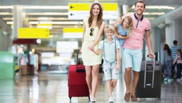tips to make family vacation more enjoyable-a couple with young kids going on a vacation