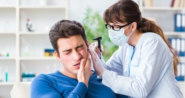 ear infection and treatments-a doctor examining a patients ear