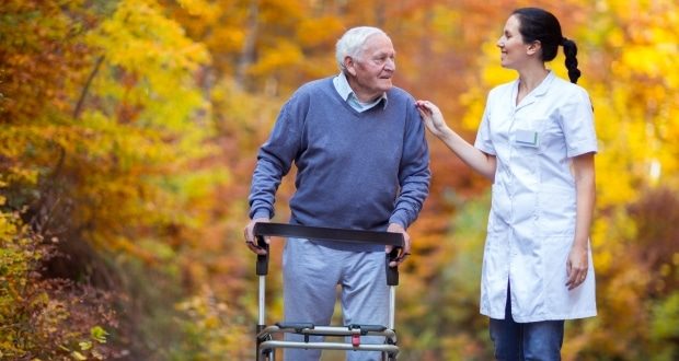 what you should know about hospice care-a caregiver and an elderly man with a walking aid