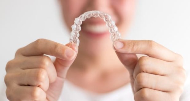 why invisalign is right for your child-a teen holding a set of invisalign