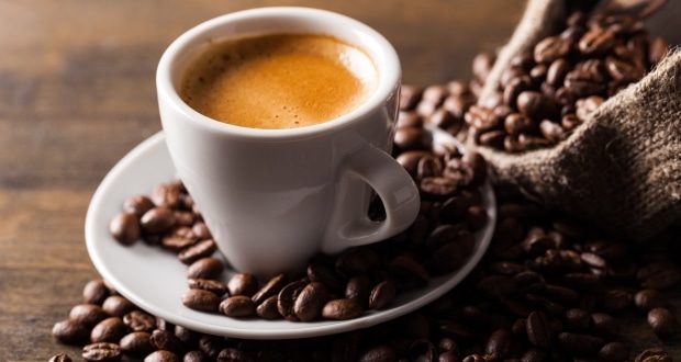 Effects of coffee on the body-a cup of coffee surrounded by coffee beans