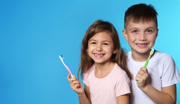 helping your kids develop morning and night routine-kids holding a toothbrush