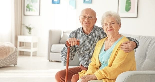 a elderly couple sitting on couch