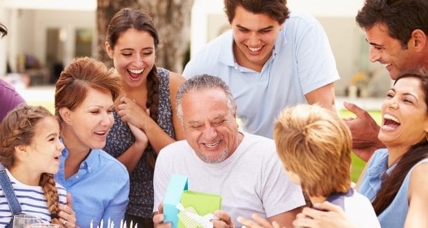 Gift ideas for your father-a dad opening a gift surrounded by family