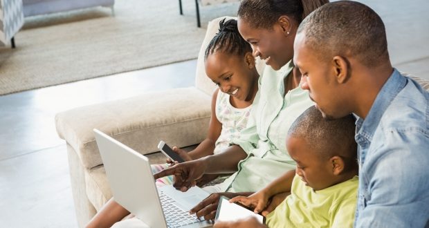 Integrating digital technology into family-life-a family looking into a laptop
