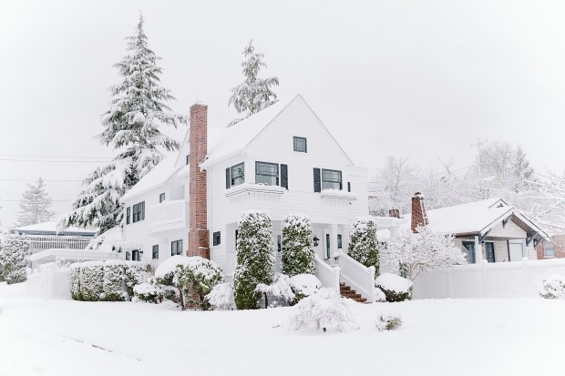 ways homeowners can prepare for winter-a house covered in snow