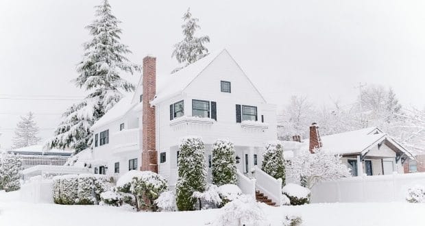 home maintenance tasks before the snow -a house covered in snow