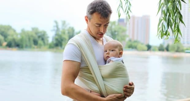 tips for going out with your new baby-a dad carrying an infant