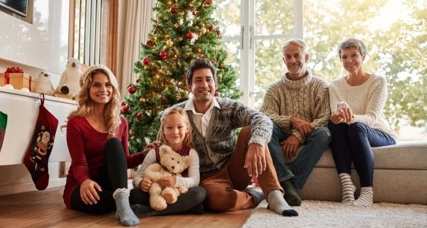 Keep your family healthy this winter-two generations family photo by a Christmas tree