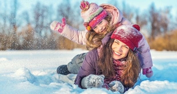 winter skincare tips for little ones-mom and dad playing in the snow