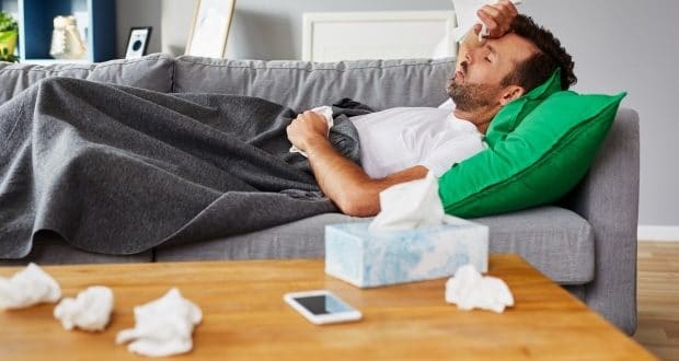 Signs your home is making you sick-a sick man on a couch