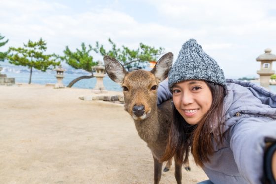 Fun Outdoor Things To Do On The Weekend - Young woman taking selfie with deer