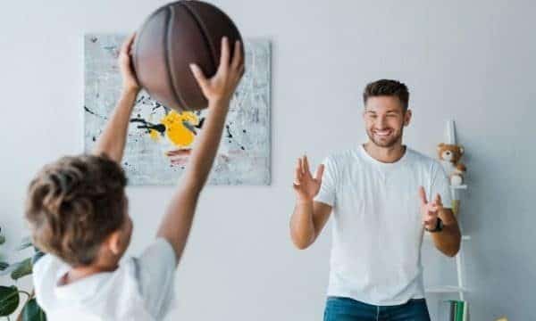 Tips to prepare your son for sports-a boy throwing a ball to his dad