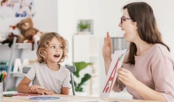 Resources to teach your child a second language-a child learning a second language with a tutor