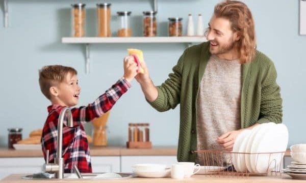 Ways stepdads can engage kids in cleaning-dad and son doing the dishes