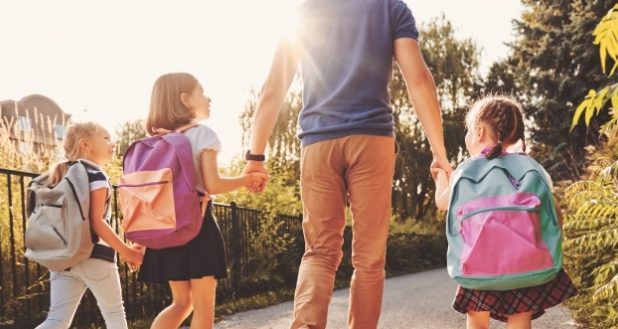 A stepdads role -A stepdad walking his kids to school