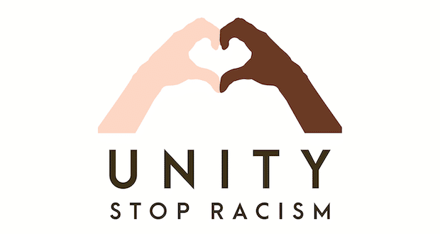 The "N" Word Isn't A Term Of Endearment For Me - picture of a white and black hands making a heart with the words unity stop racism underneath