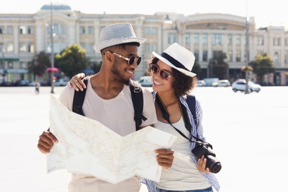 tips when buying a gift for that special someone - African-american tourist couple taking photos on camera on street