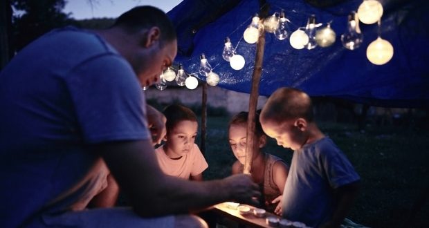Summer entertainment ideas for your backyard-A dad playing games with his kids