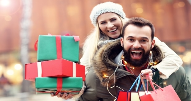 Christmas shopping jokes and one liners- A happy couple surrounded by gifts