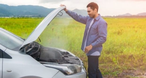 Things to do if your car overheats-A man infront of a car overheating