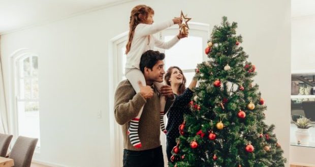 Christmas winning tips for every stepdad-A stepdad setting up a Christmas tree