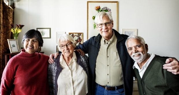 Group of senior friends with their arms around each other