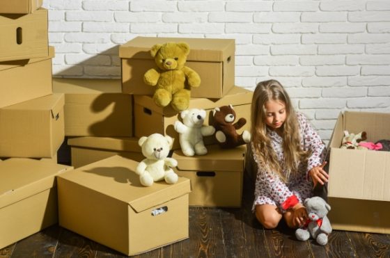 Moving into a new home with your stepkids-a girl unboxing her teddies