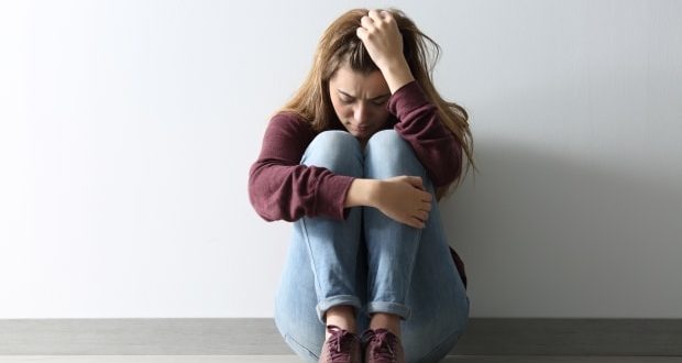 Facts to know about depression-A depressed girl sitting on the floor